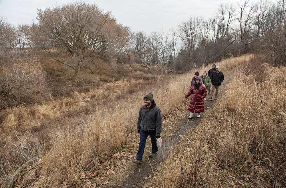 Milwaukee County Parks Department Trails Coordinator Jacob Sanchez leads the group on the Forked Aster Trail in Warnimont Park.