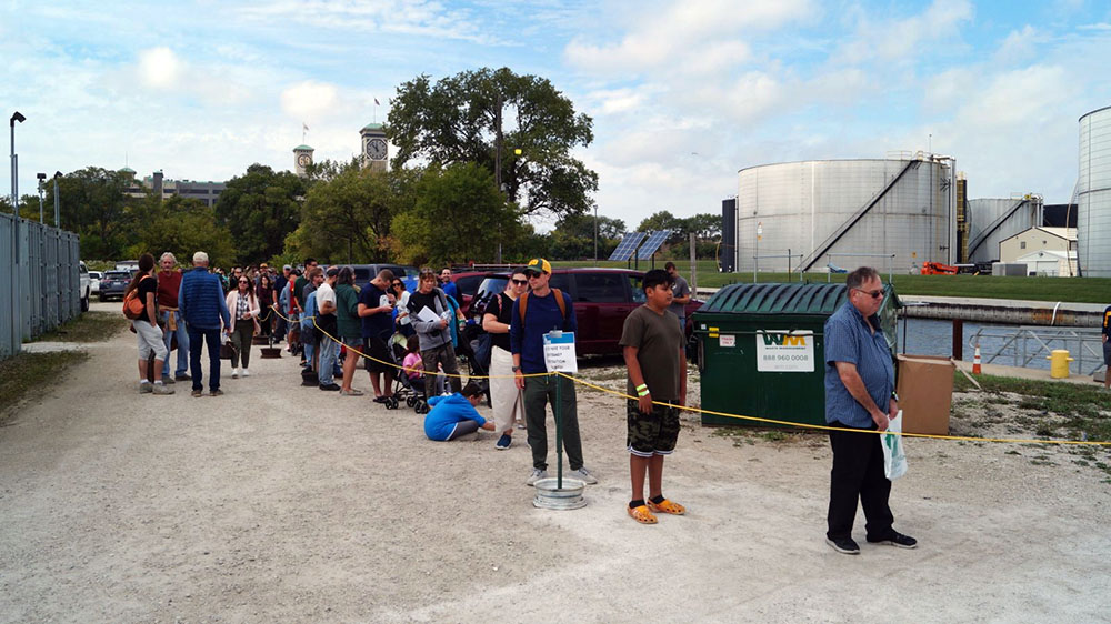 The long line at Sturgeon Fest 2023 to release 590 sturgeon into the harbor and Lake Michigan.