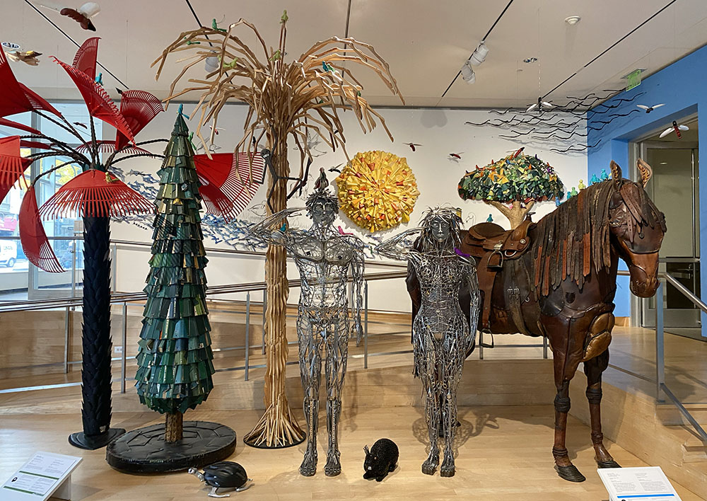 Trees, humans, horse; mixed media