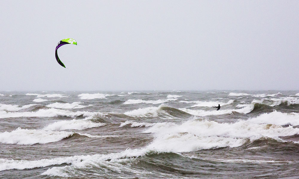 Parasailer in rough surf at Bradford Beach, Milwaukee.