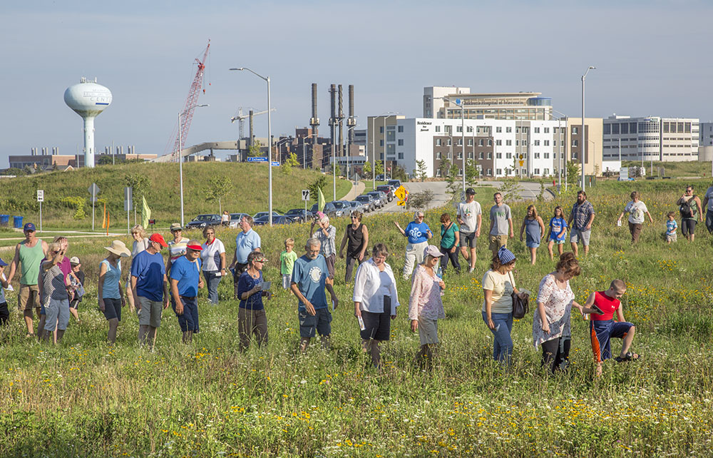 A group hike organized and guided by Friends of the Monarch Trail, showing the proximity of the trail to the Milwaukee Regional Medical Complex.