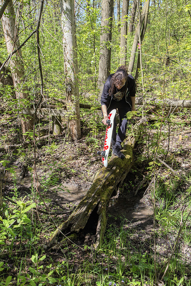 Mycological Society at UWM member crossing a rill on a log.