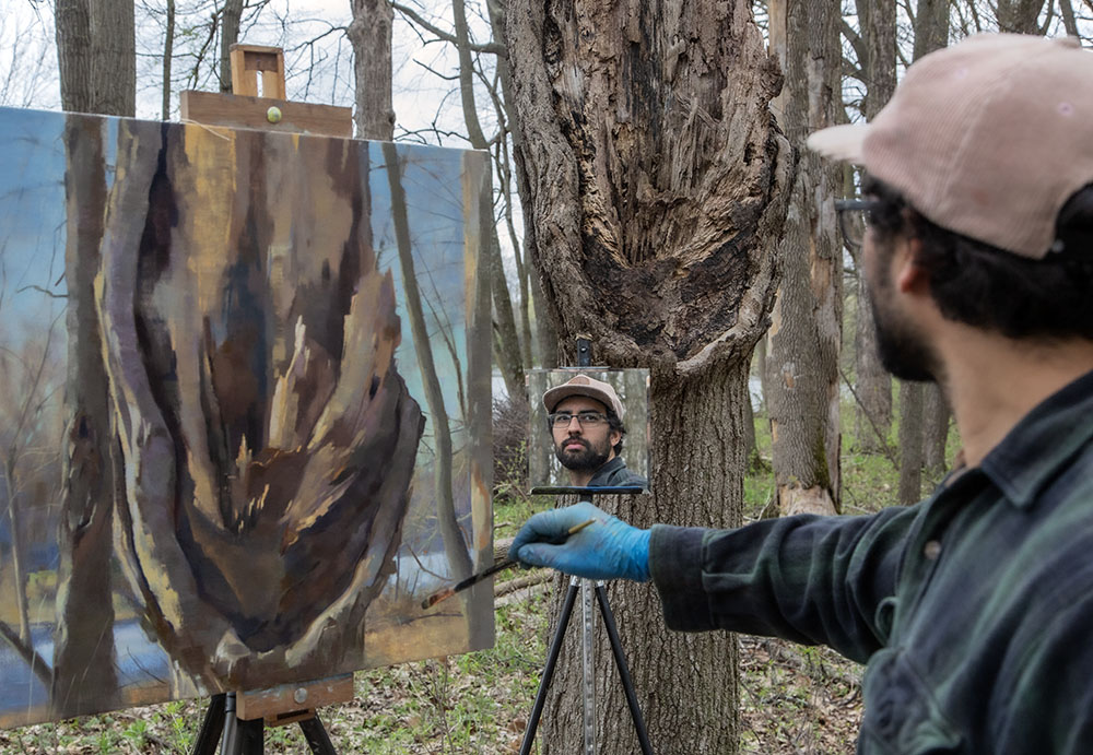 Hector Acuna painting his tree portrait en plein air. 