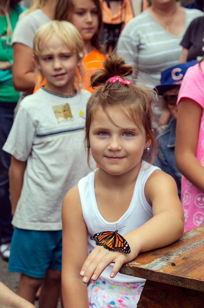 A young participant in a monarch tagging event at Forest Beach Migratory Preserve.