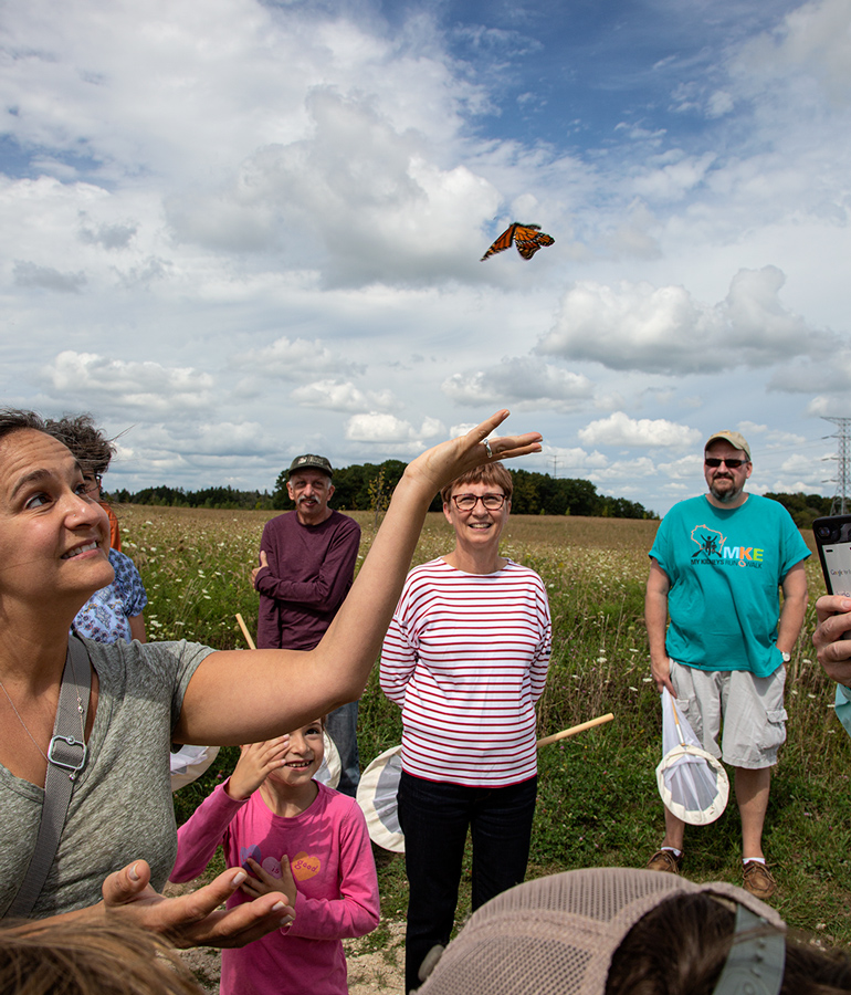 Releasing a monarch after tagging at Mequon Nature Preserve.