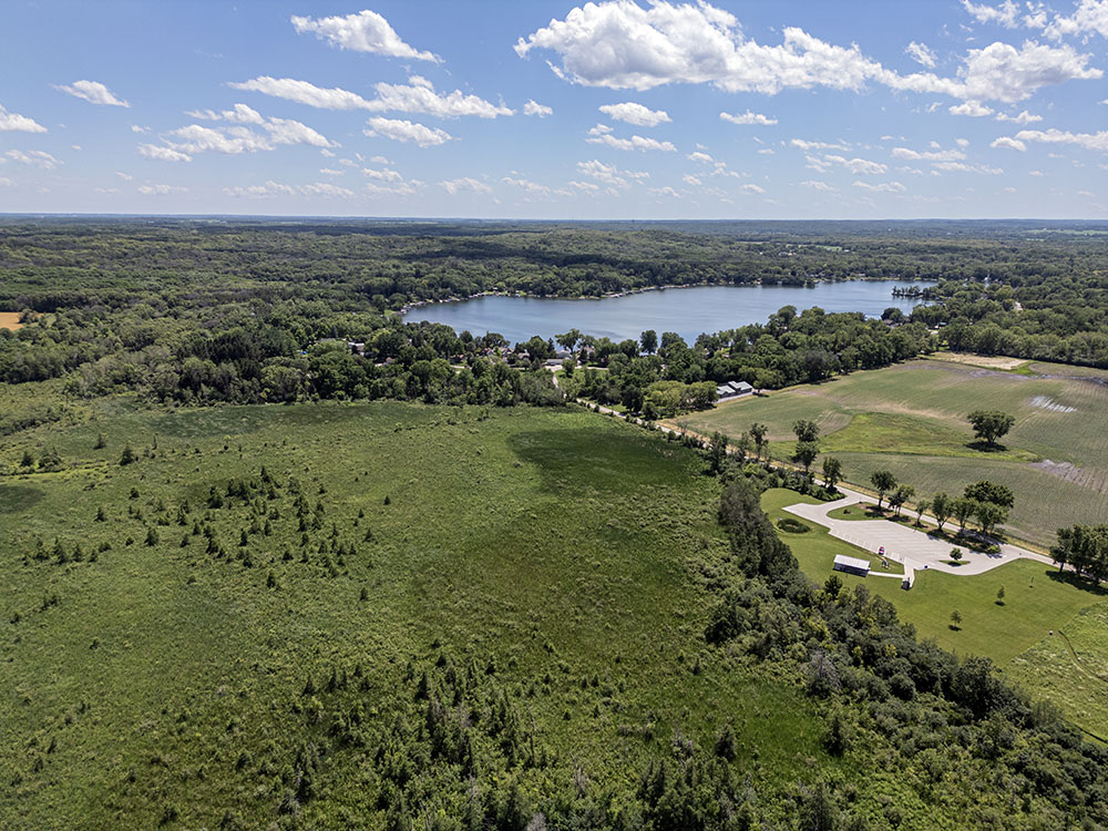 Aurelian Springs Park in Palmyra is largely impassable wetland, but includes a small prairie with trails as well as a woodland trail along the edge of the wetland. The springs feed Blue Springs Lake in the background.