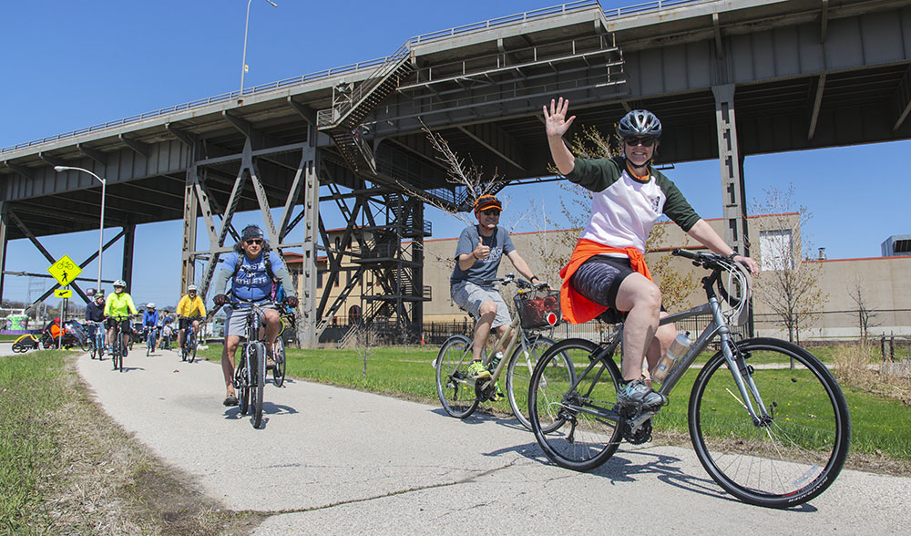 Cyclists in the shadow of the 35th Street Viaduct on the Hank Aaron State Trail in the Menomonee Valley of Milwaukee.