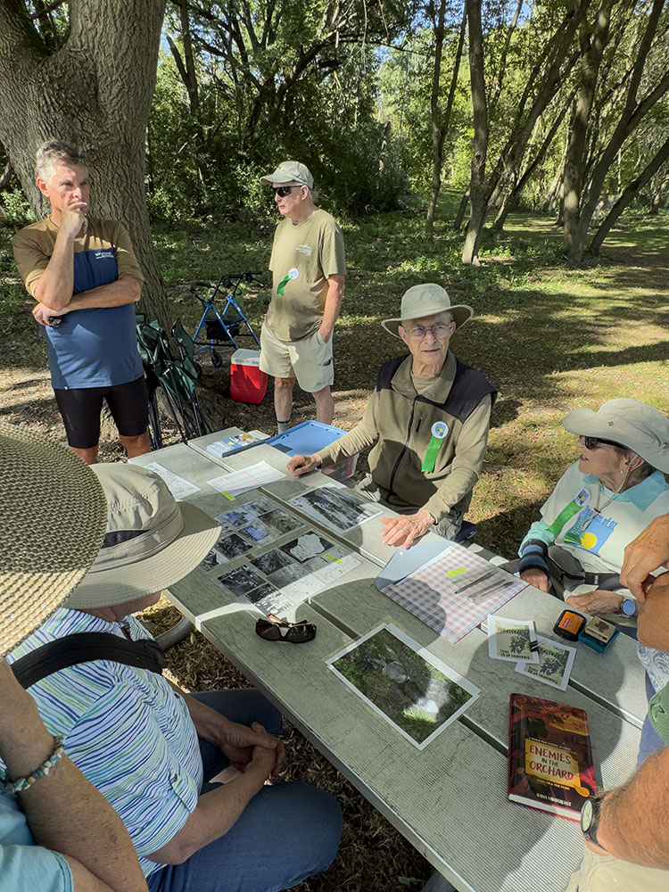 history buffs Jim and Katie (seated) sharing information and photos about German prisoners of war held in Ozaukee County during WWII