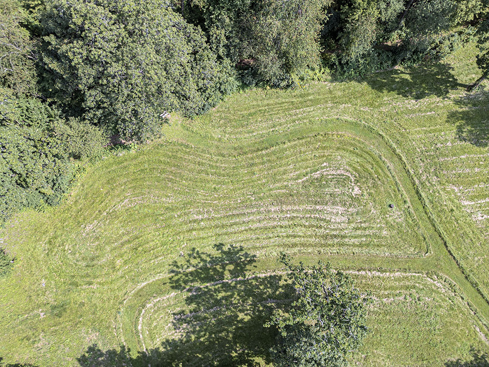 Aerial view of a mound articulated by mowing patterns.