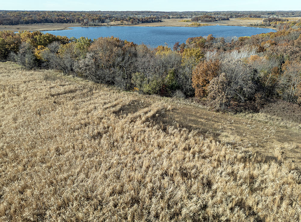 Restored prairie (foreground) provides nearly a quarter-mile buffer between active agriculture and Lulu Lake (background).