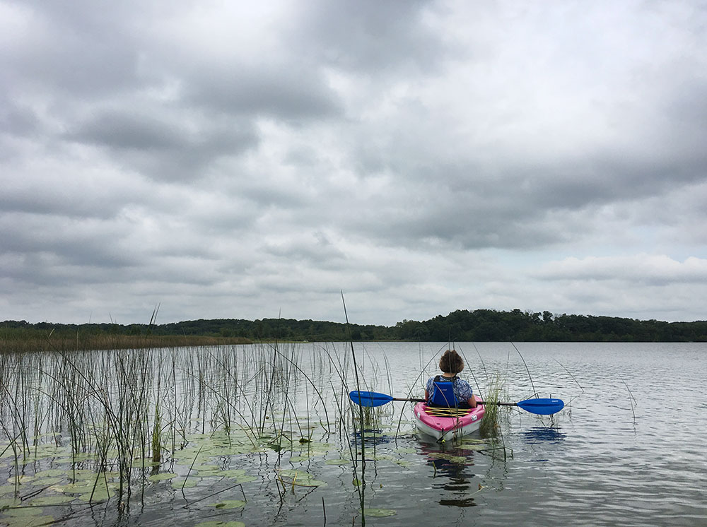 A kayaker rests in the reeds on Lulu Lake.