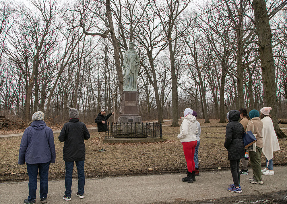 Adam Carr with the Milwaukee Parks Foundation points out the statue to Commerce.