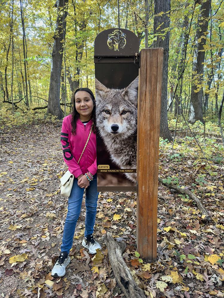 Lynn posing next to the coyote.