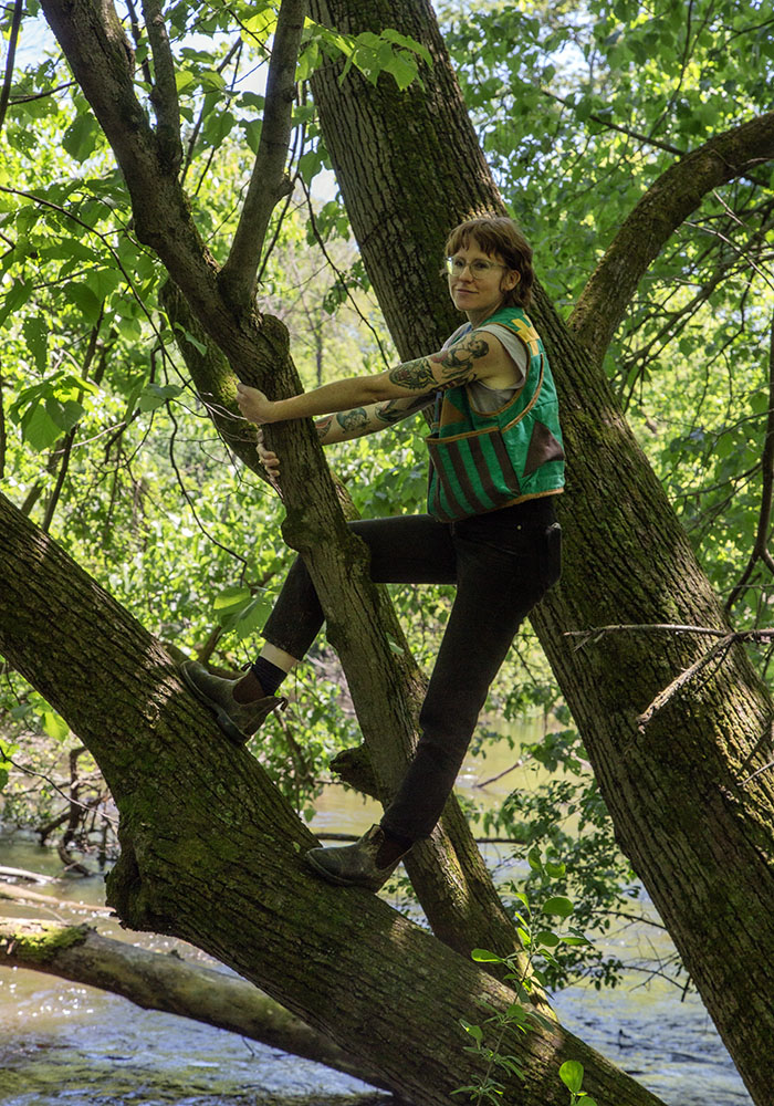 Amanda Tollefson on a tree overhanging the Oconomowoc River.