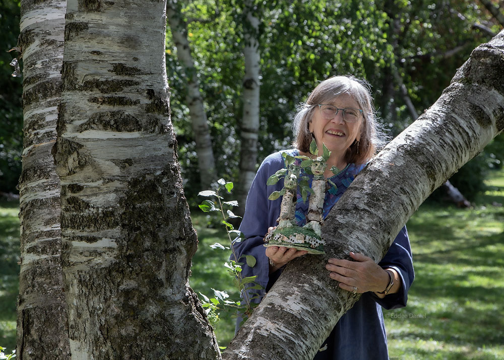 Darlene Wesenberg Rzezotarski with her beloved birches in Estabrook Park and a sculpture inspired by them.