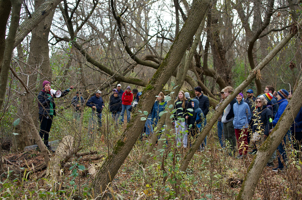 The group pauses to learn about restoration plans from Catie Petralia, Volunteer Coordinator with RRF.