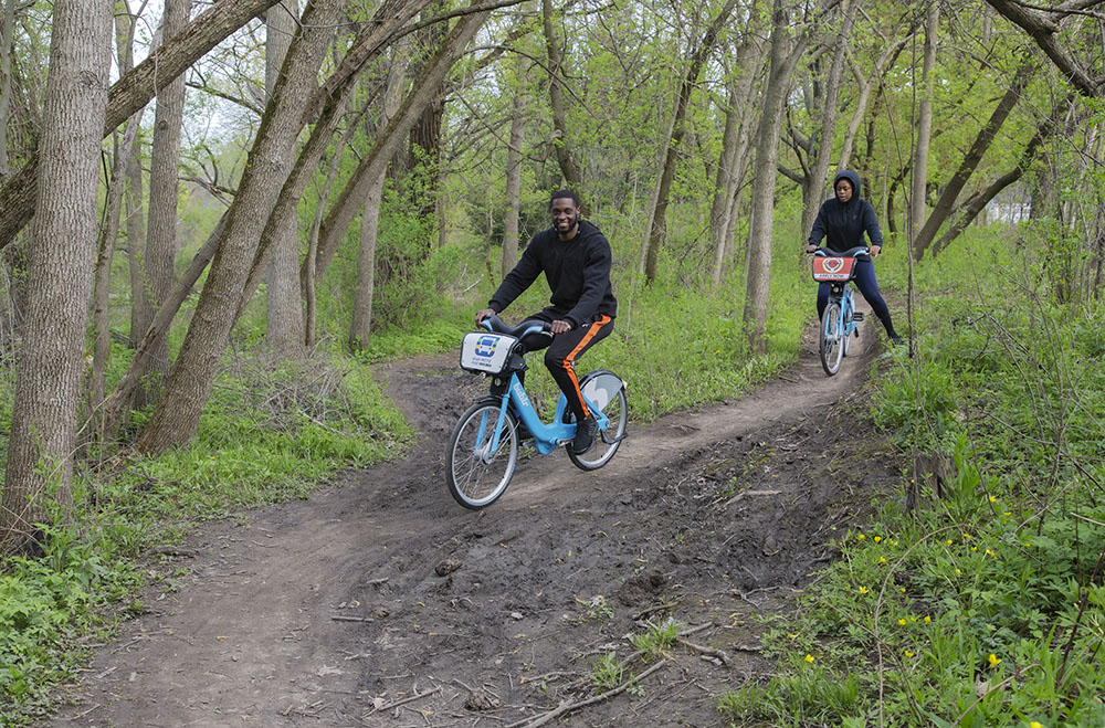 A young couple uses Bubblr bikes to ride the Hoyt Mountain Bike Trail.