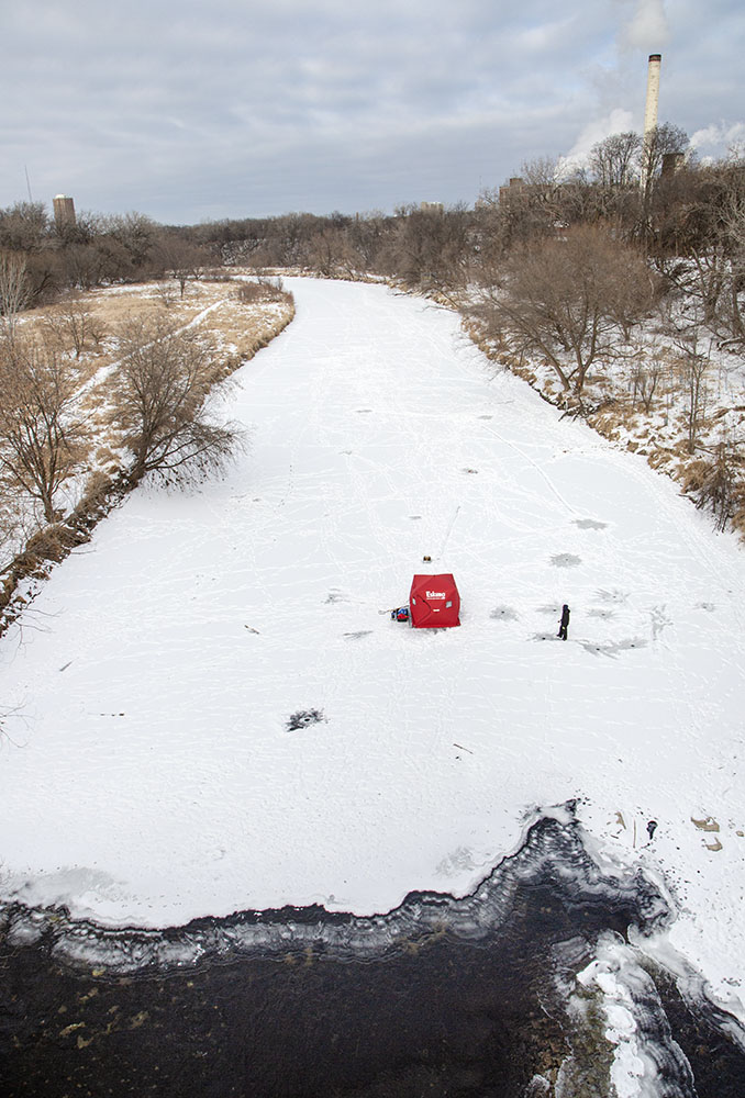 The same fishermen, above, showing their proximity to open water where the faster current keeps the river from freezing, under the North Avenue bridge.