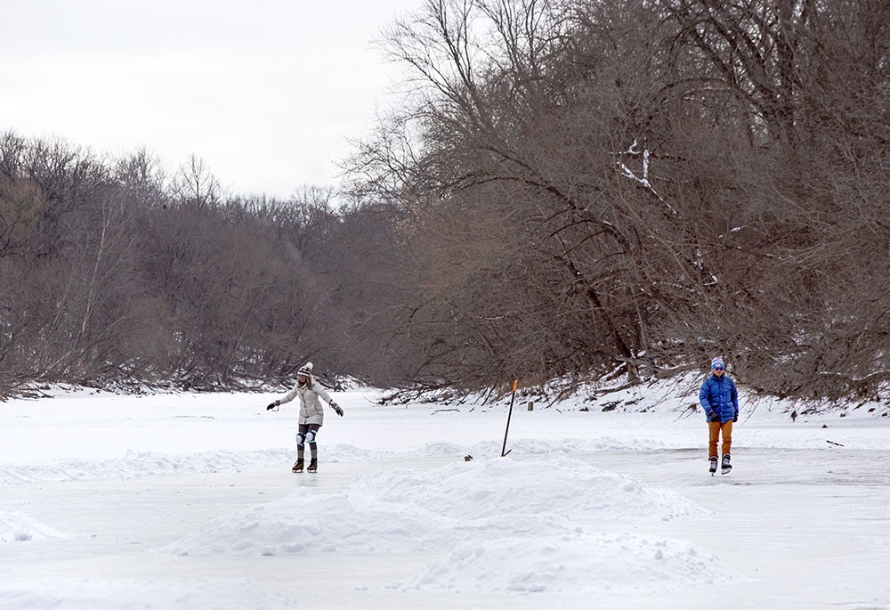 Skating on a cleared section of the Milwaukee River at Pleasant Valley Park in the Milwaukee River Greenway.