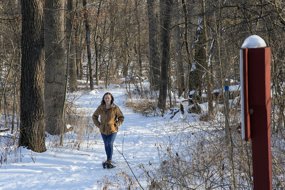 Naturalist Liz Alvey snowshoeing on one of the Bristol Park trails.