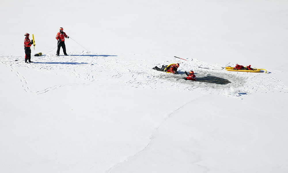 A Milwaukee Fire Dept. rescue team practicing water rescue on the frozen Milwaukee River at the Third Ward in Milwaukee.