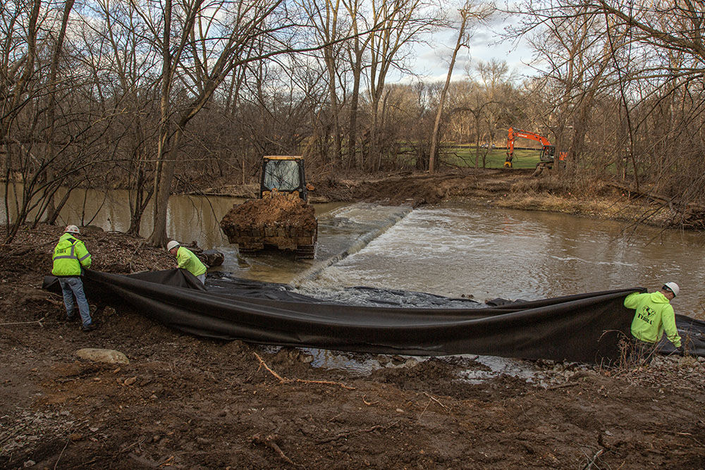 A crew preparing to remove one of five impediments in 2015 in the river to enable fish to migrate. Called the "carwash" because, at one time, a vehicle could drive across it when the current was low in order to access the landfill on the south side of the river.