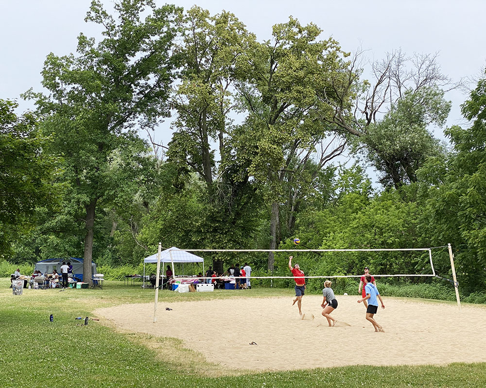 Sand volleyball next to the playground and pool.