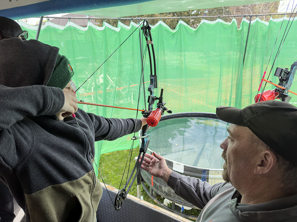 Bow fishing activity. This young student hit the target fish in the tank first time!