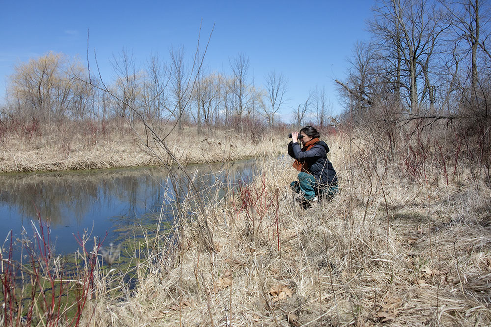 Sophie Hughes and her binoculars at Forest Beach Migratory Preserve.