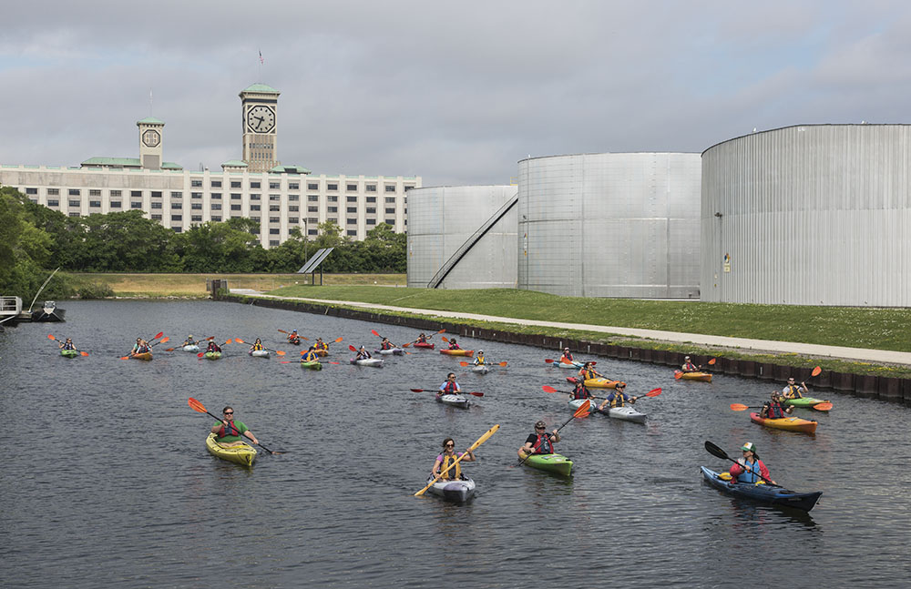 A group of kayaks touring Milwaukee's Inner Harbor.