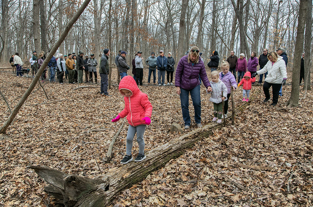 The large group included a number of children, who amused themselves and watching adults by walking on every log they could get to.