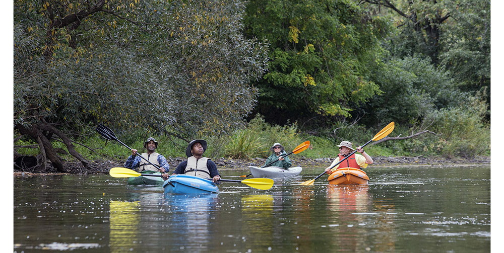 Four kayakers on the Milwaukee River in Lincoln Park