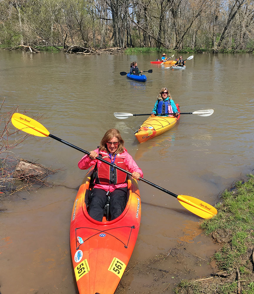 Root River Challenge paddlers approaching the boat launch at River Bend Nature Center.