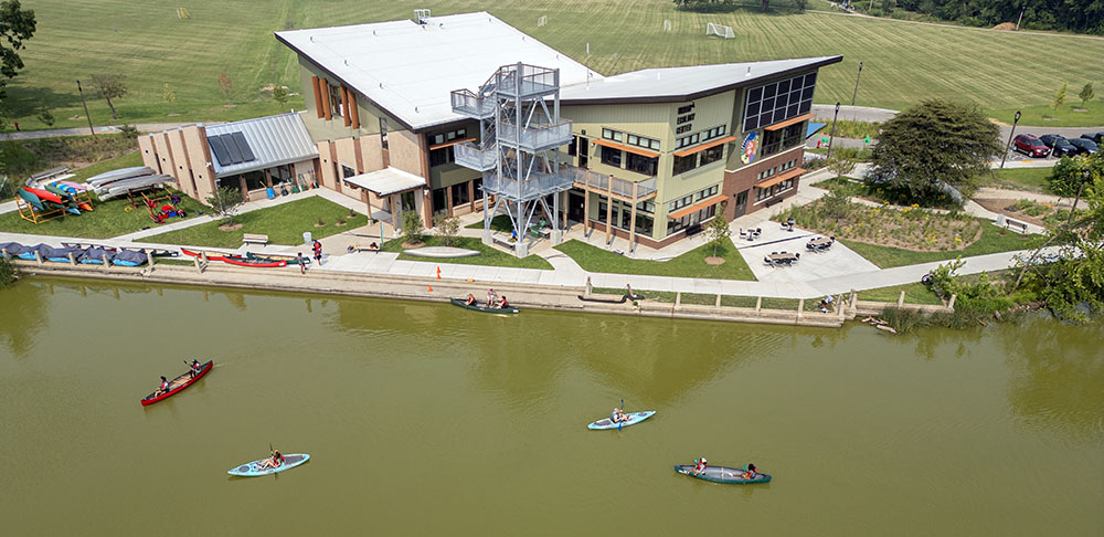 Boaters on the lagoon in front of the Urban Ecology Center in Washington Park