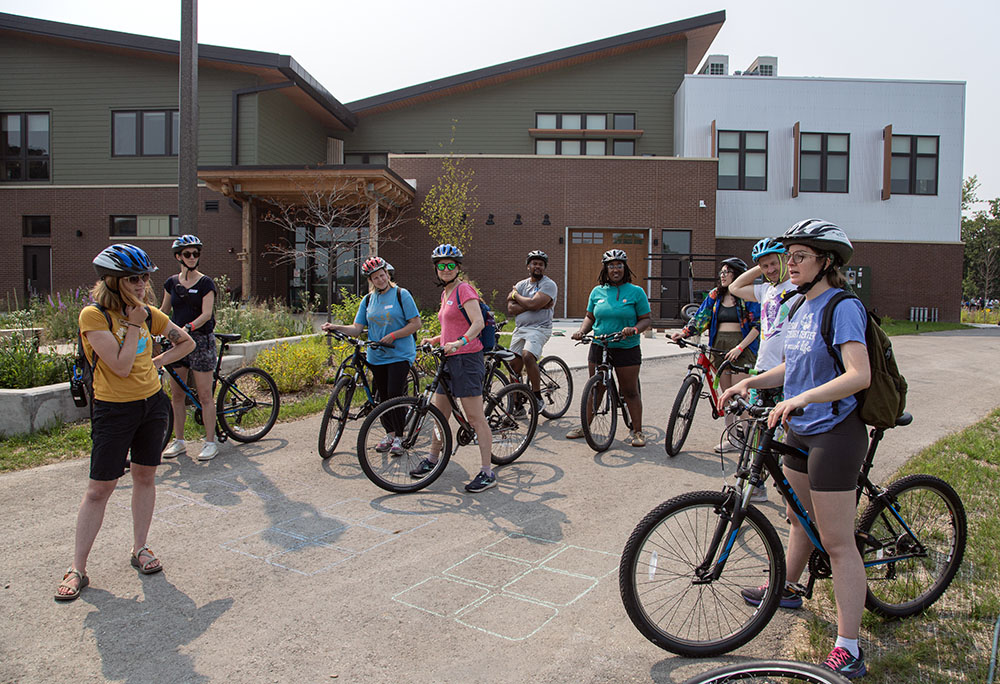 A group of cyclists prepare to ride around the park pathways.