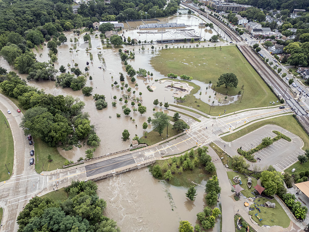 An aerial view of Hart Park shows that a substantial portion of the floodwater is contained within the park. Traffic moved unimpeded through Wauwatosa Village along State Street, on the right side of the image.