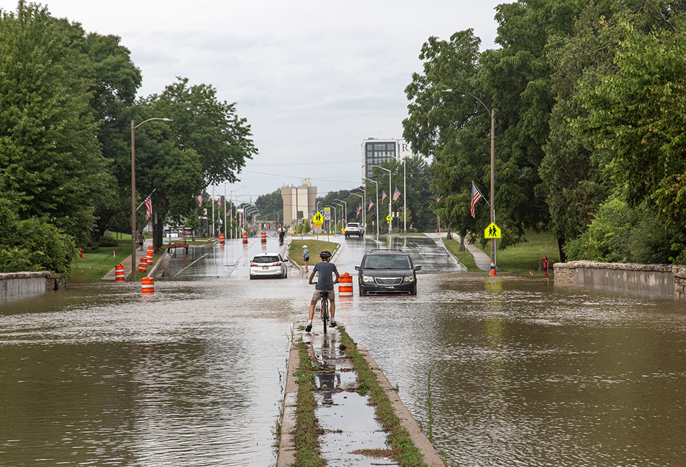 Cars stalled in the water where the river flowed over the bridge at North Avenue in Wauwatosa.