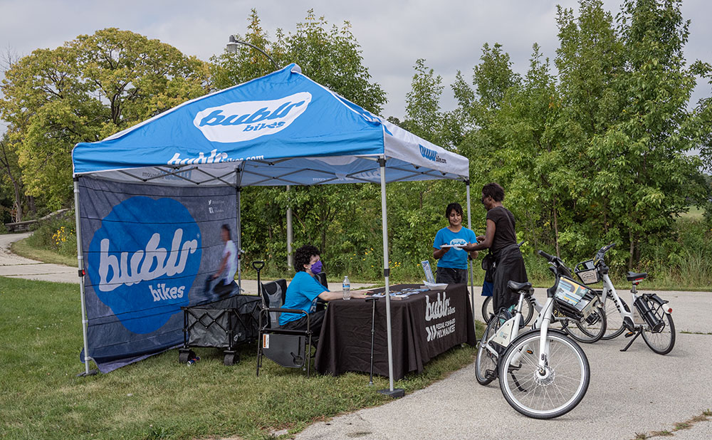 Bubblr Bikes station. The banner photo at the top is also of people riding Bubblr Bikes in the park.