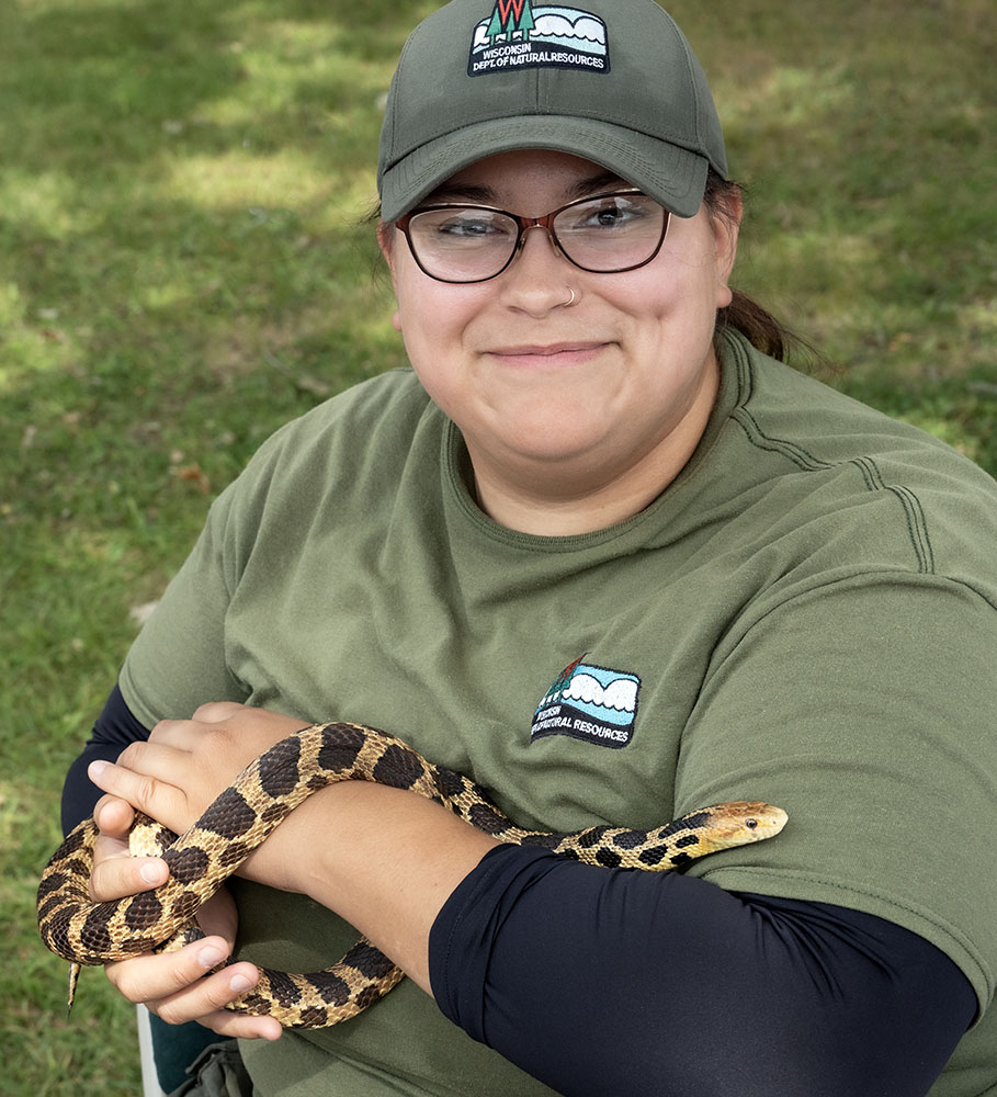DNR educator Debbie with Foxy the fox snake, who normally lives in the Education Center at Havenwoods State Park.