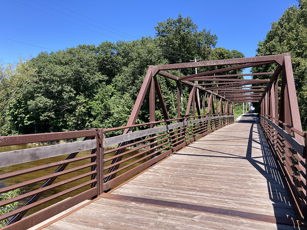The Interurban Trail bridge over the Milwaukee River with Bratt Woods to the north at left.