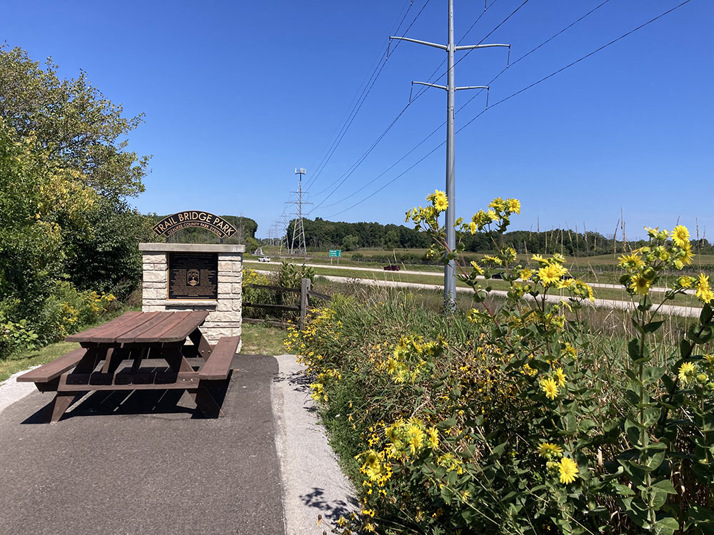 A rest spot beside I-43. The trail is visible in the distance.