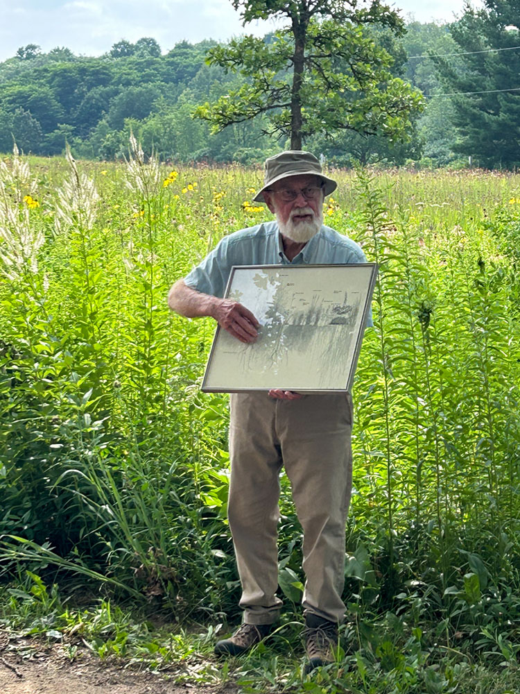 Dr. Marlin Johnson explains the how the root depth of the native prairie plants helps them survive drought and prevent erosion.
