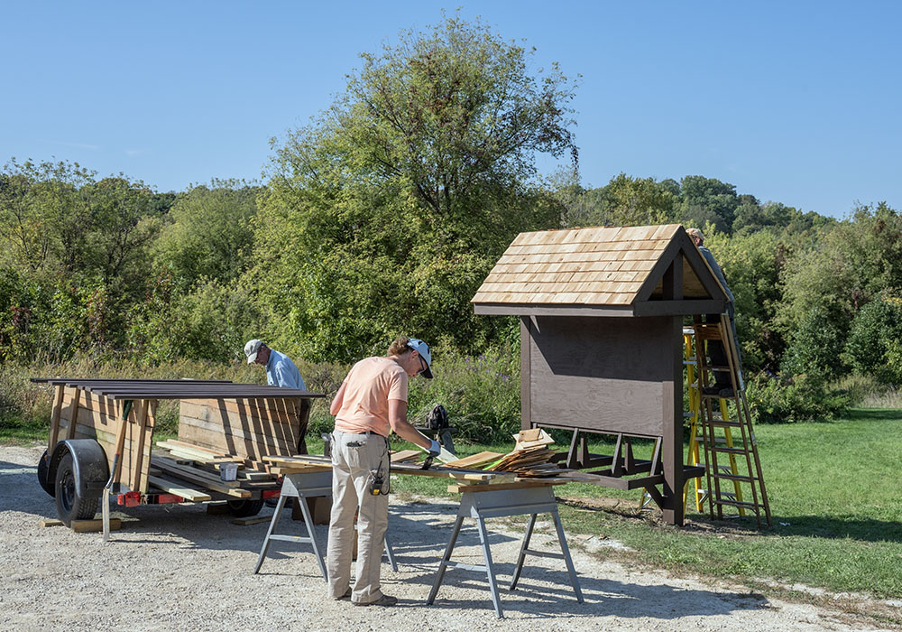 A new informational kiosk being built and painted at Fox Hill.