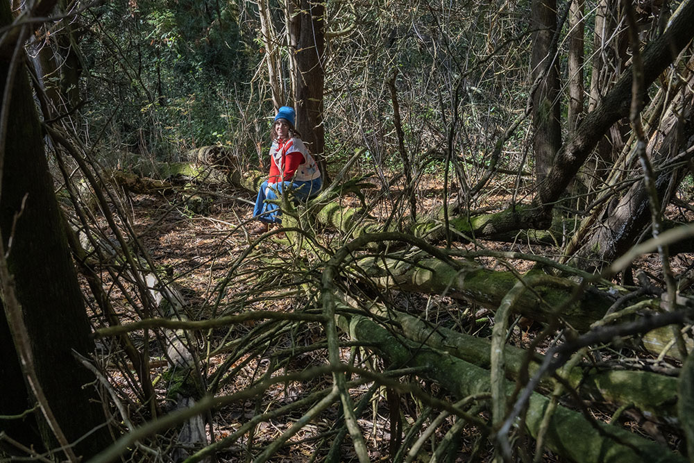 Lesley among moss-covered logs at Schoofs Preserve. Photo by Eddee Daniel.