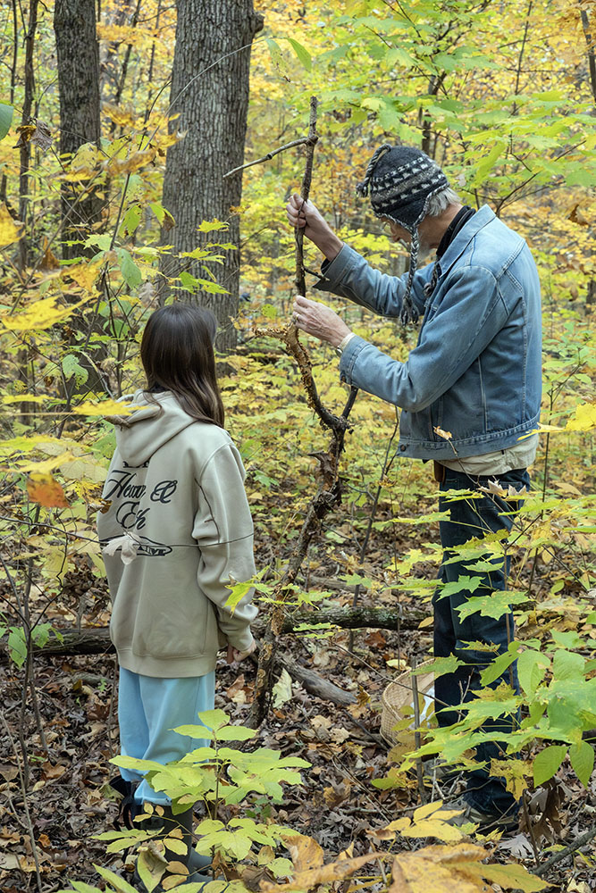 Examining a fungal growth on a stick.