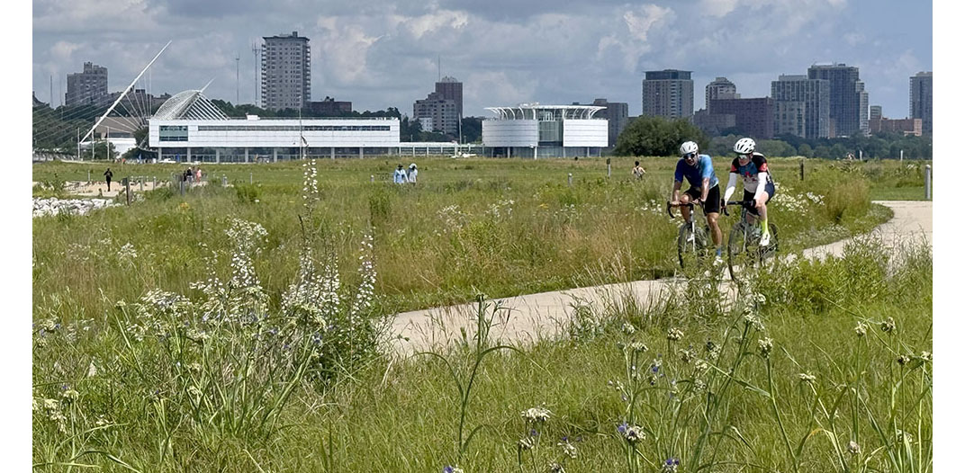 Cyclists riding through the prairie on the Oak Leaf Trail in Lakeshore State Park