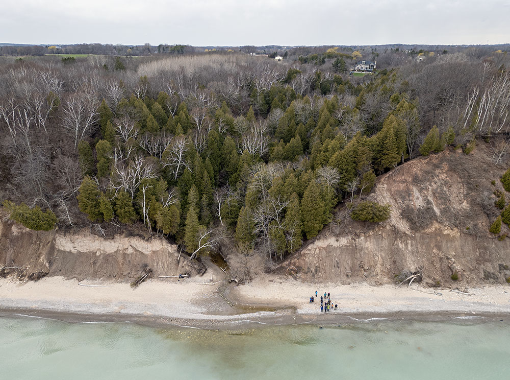 Aerial view of the group on the beach in front of the gorge.