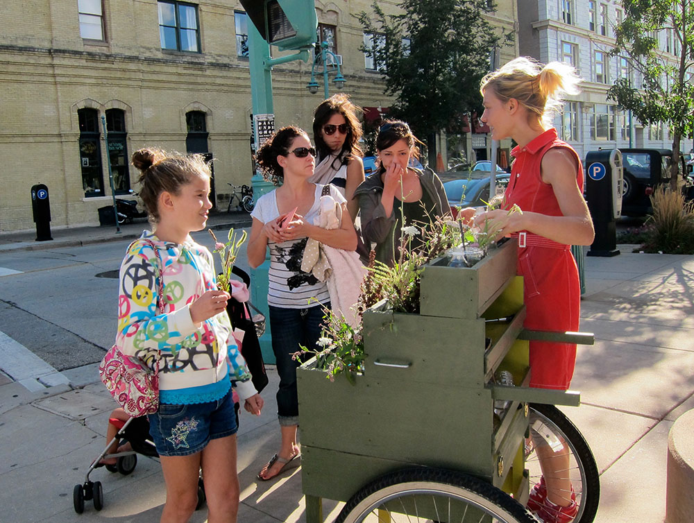 Distributing flowers as part of Milwaukee: Spaces to Places to spark conversation about geography and segregation.