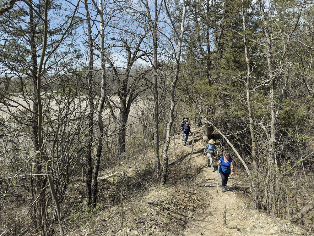 Hikers on the glacial terrain at Wehmhoff Woodland Preserve in Burlington.