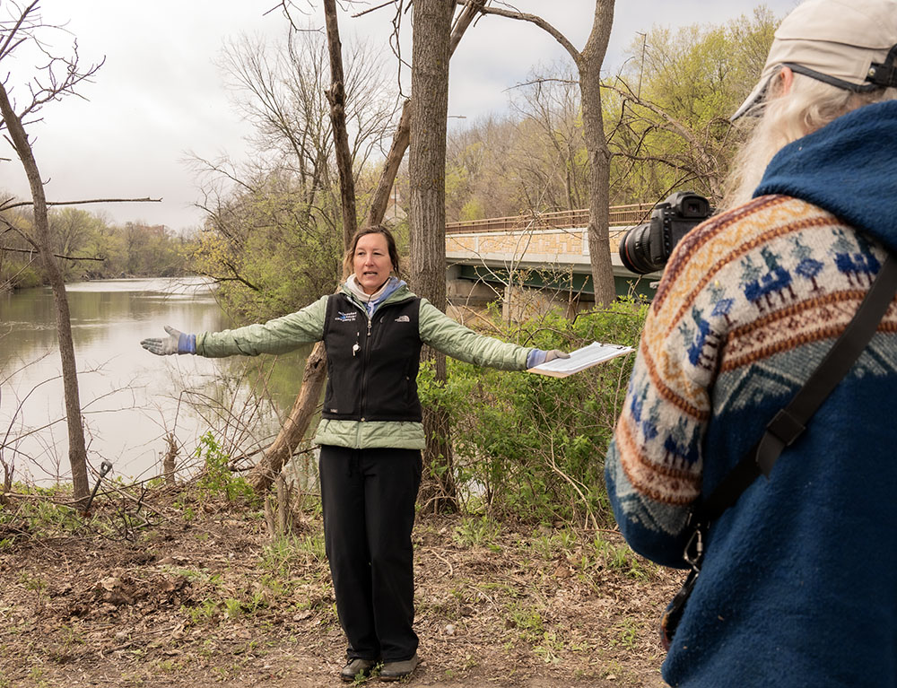 Beth Handle, owner and founder of Milwaukee Kayak Co., making a promotional video in support of the cleanup next to the KK River.